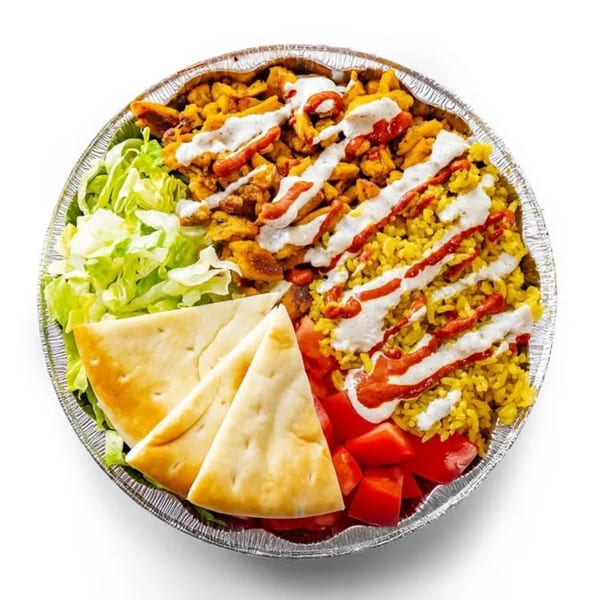 Classic Gourmet Deli and Grill's chicken over rice with lettuce, tomatoes, pita, white and hot sauce.